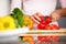 Peppers - woman cutting red pepper