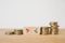 Percent up and down icon on wooden cube blocks with stack of coins for business strategy, growth and planning concept