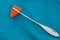 Percussive reflex hammer on green surgical scrub background