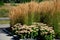 Perennial beds mulched with dark stone gravel with a predominance of ornamental grasses