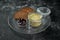 Perfect appetizer - chicken liver pate in jar with jam and rye bread on black background. Close up, selective focus