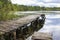 Perfect background forest lake with trees and old wooden walkways