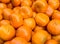 Perfect background of ripe clementines for sale at the market