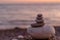 Perfect balance of stack of pebbles at seaside towards sunset.