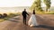 Perfect bride looks over her shoulder while walking with groom