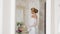 Perfect bride standing near mirror