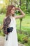 Perfect bride woman in white dress holding bird outdoor