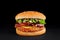 Perfect burger with cutlet, cheese, bacon, tomato, lettuce isolated at black background