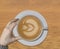 Perfect cappuccino with latte art tulip design on yellow wooden