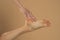 Perfect clean female feet . Beautiful and elegant groomed woman`s hand touching her foot . Spa ,scrub and foot care