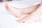Perfect clean female feet .Beautiful and elegant woman`s, girl foot .Spa ,scrub and foot care concept.Light room, clean bedding
