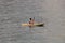 Perfect day for kayaking. Beautiful young woman paddling while sitting in kayak