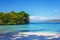 Perfect empty Caribbean sandy beach with clear water and green palm trees