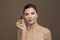 Perfect female face and natural oil bottle. Facial treatment and alternative medicine concept