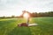 Perfect flexibility. Beautiful couple practicing acro yoga together outdoors on a sunny morning. Man lying on a mat and