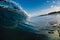 Perfect glassy wave in sea. Crashing surfing wave and sky