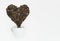 Perfect heart shape made of coffee beans pour out cup on white background. Flat lay, minimal design. Symbol of Love to