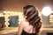 Perfect long curly hair. Back, side view. Brunette in makeup room with studio lights.