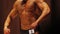 Perfect masculine torso of strong bodybuilder showing muscles at fitness contest