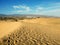 A perfect match of the sky patterns, white town and the hot sand gold, Tenerife, Canary Islands