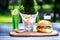 Perfect meat burger with french fries and fresh cold lemonade. On the cutting board, and green summer background.