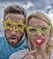 Perfect for photo fun. Funny couple in party photobooth props. Couple in love enjoy party time on cloudy sky. Pretty