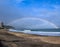 A perfect rainbow over the beach of Hebara in Chiba Japan with surfers and waves breaking