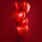 Perfect red heart balloons composition on bright red card background