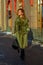 Perfect redhead woman fashion model in green coat outdoor