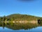 Perfect reflection of a small hill in Bargain Bay, near Pender Harbour