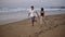 Perfect scene. Couple enjoy summer vacation on the large beach, enjoy life and running in scenery slow motion video on