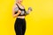 Perfect sporty female working out with dumbbells. Photo of woman in sportswear, studio