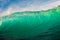 Perfect surfing wave in sea. Breaking turquoise wave with sun light