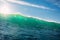 Perfect surfing wave in sea. Breaking turquoise wave with sun light