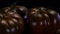 Perfect tomatoes rotating on a black background, close up view. Fresh and firm sweet chocolate tomato in 4K
