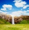Perfect view of famous powerful Seljalandfoss waterfall in sunlight