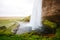 Perfect view of famous powerful Seljalandfoss waterfall in sunlight