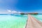 Perfect view of luxury water villas in Maldives island. Blue sea and blue sky, idyllic sea view from a wooden pier pathway