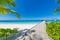 Perfect view of luxury water villas in Maldives island. Blue sea and blue sky, idyllic sea view from a wooden pier pathway