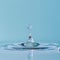 Perfect Water Droplet Creating Ripples on Serene Blue Surface