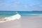 Perfect waves in cristaline waters beside Two Brothers Cliff, Cacimba beach, Fernando de Noronha island, Brazil