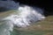 Perfect waves in cristaline waters beside Two Brothers Cliff, Cacimba beach, Fernando de Noronha island, Brazil