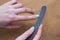 Perfect Woman hands with beautiful fingernails and a nail file