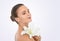 Perfecting perfection. Studio beauty shot of an attractive brunette woman holding a flower.