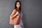 Perfectly accessorized with my bag. Studio portrait of an attractive young woman holding her handbag.