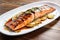 perfectly charred salmon on white platter, caramelized apple cider glaze