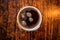 a perfectly chilled pint glass filled with dark beer, shot from above