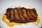 A Perfectly Grilled Steak Plated on a Pure White Background