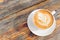 Perfectly Poured Latte in Top-View on a wooden table