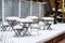 Perfectly shaped snow on table and chairs, covered with snow